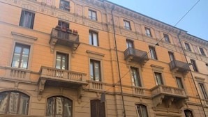 A multi-story building with balconies and large windows. - SUYTE Torino Centro (Turin)