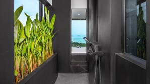 A modern hallway with a view of the sea, a glass shower enclosure, and a plant wall. - SOMA 4 Bedrooms SEAVIEW Pool Villa (Koh Samui)