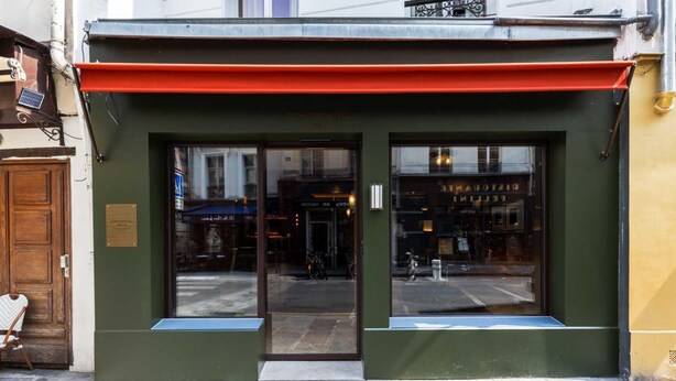 A building with a green facade, a red awning, and large glass windows. - Confidential Room 3, a Stone's Throw From the Louvre (Paris)