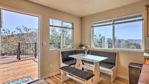 A room with a bench, a table, and a view of the outdoors. - Charming Oakhurst Retreat Near Yosemite, Bass Lake (Oakhurst)