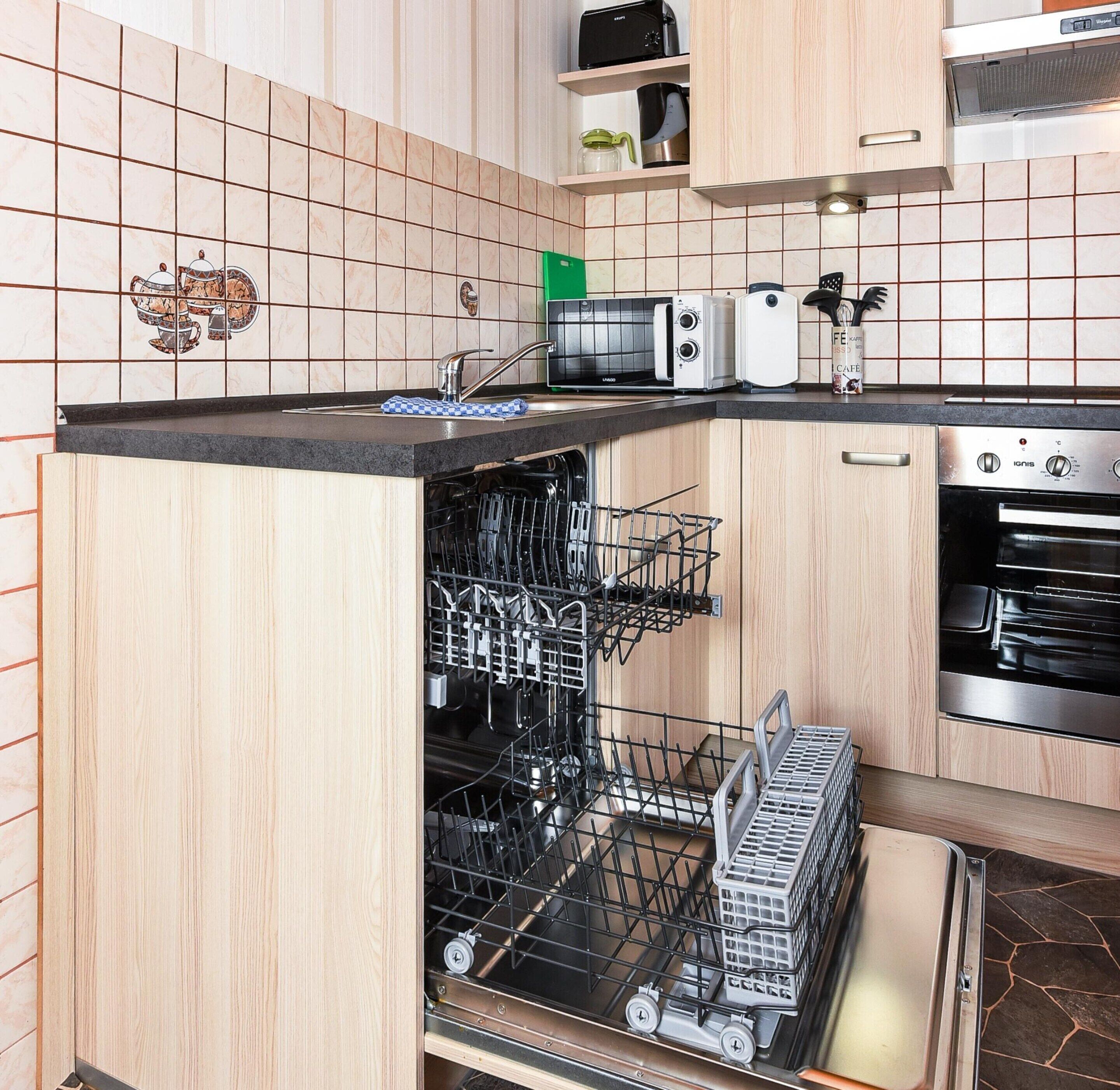A kitchen with a dishwasher, a toaster, and an oven.
