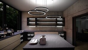 Une cuisine moderne dotée d’un îlot central, de luminaires suspendus et offrant une vue sur l’extérieur.