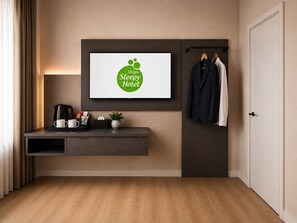 A hotel room with a framed logo, a coffee station, a coat rack, and a door. - SleepySleepy Hotel Fulda  (Fulda)