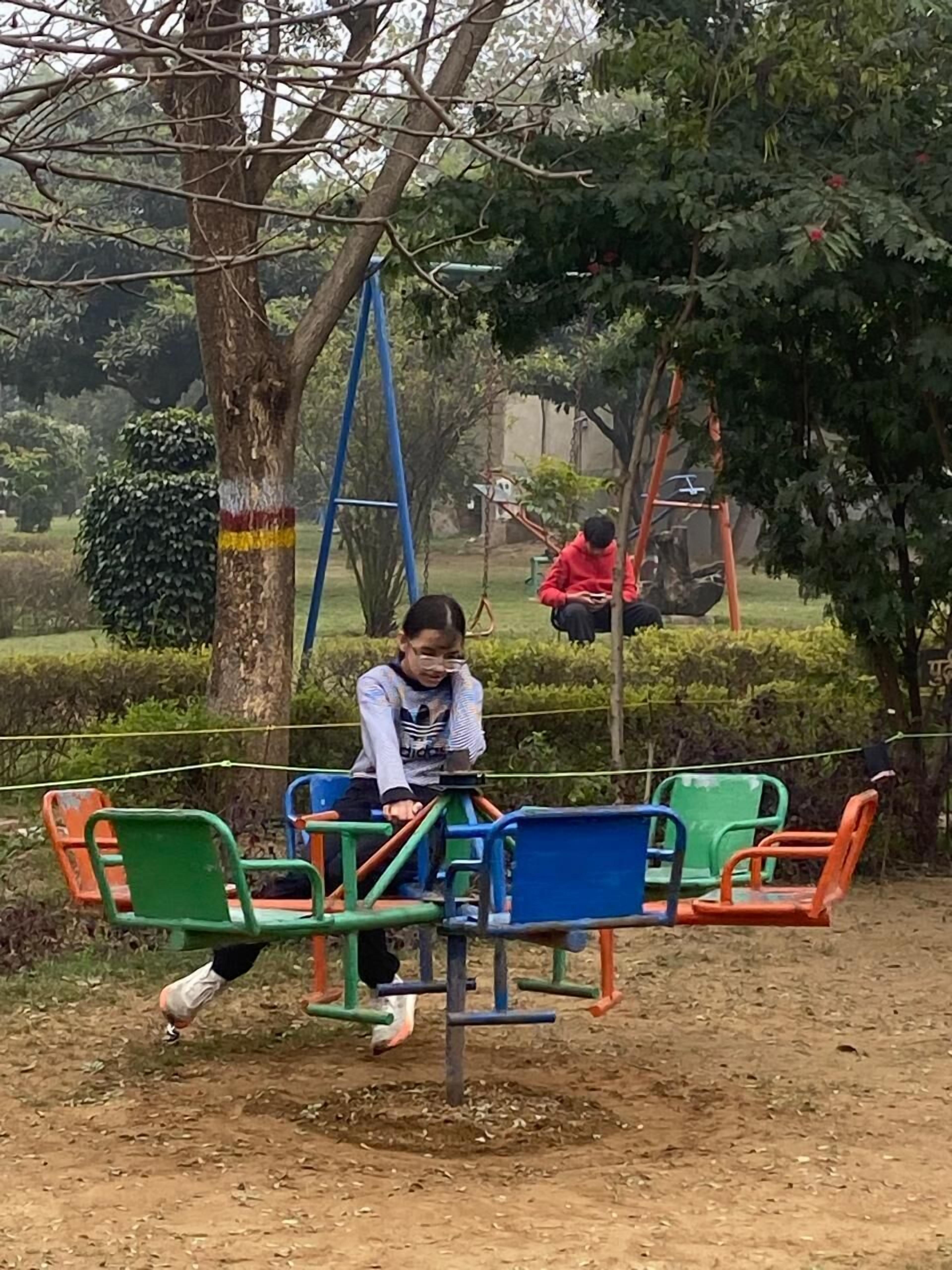 A playground with swings and a seesaw.