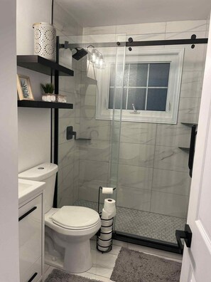 Shower, towels, soap, toilet paper