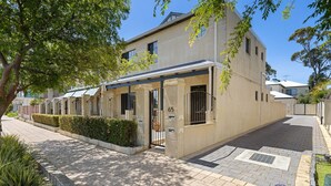 A residential building with a gated entrance, a covered outdoor area, and a paved driveway. - 3 bedroom Villa walking distance to Mandurah foreshore (Mandurah)