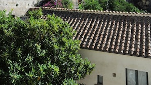 A coastal town with terraced buildings, a prominent cliff, and a mix of residential and historical architecture. - B&B La Cascata   Camera Positano (Amalfi)