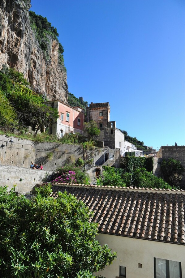 A coastal town with terraced buildings, a prominent cliff, and a mix of residential and historical architecture.