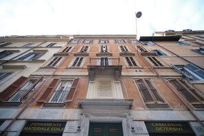 A multi-story building with numbered windows and doors, indicating a structured layout.