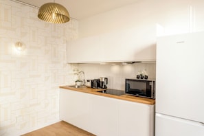 Apartamento, vistas al patio | Cocina privada | Frigorífico, microondas, placa de cocina y tostadora