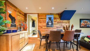 A cozy cafe with wooden walls, a wooden counter, and a table with chairs. - Cornish cottage.  Sleeps 8.  Dog friendly.  Lake views.  Close to the coast. (Millbrook)