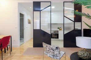 Ein modernes Interieur mit Essbereich, Küche und einer Zierpflanze.