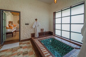 A bathroom with a large window, a bathtub with mosaic tiles, and a wooden floor. - Dunes and You, Pushkar - A Luxury Pool Villas Retreat (Pushkar)