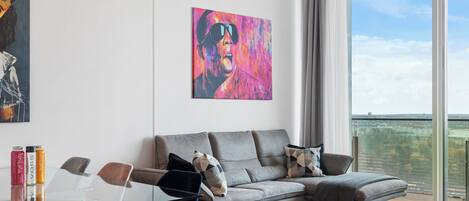 Deluxe Penthouse, 2 Bedrooms, Pool Access, City View | Living area | 60-inch LED TV with digital channels, Netflix, heated floors