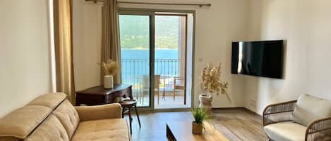 Apartment, Balcony, Sea View | Living area | TV