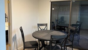 A dining area with a round table and six chairs, a ceiling fan, and a sliding glass door to the outside. - Marvelous 3-bedroom house located on a horse farm in Ocala minutes from WEC (Ocala)