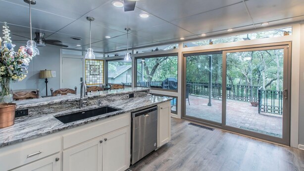 A modern kitchen with a large island, stainless steel appliances, and a view to an outdoor deck. - Marlandwood Estate - Spacious 5-bedroom house in Temple with outdoor space (Temple)
