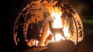 A spherical object with a deer silhouette and a flame inside, possibly a decorative piece. - Terrific 5-bedroom house with AC in charming Princeton (Princeton)