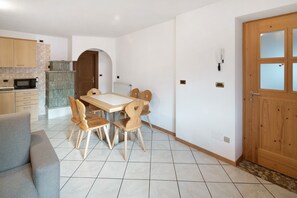 Une cuisine moderne équipée d’un four à micro-ondes, de meubles en bois et d’un coin repas avec une table et des chaises.