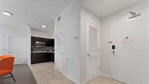 A modern apartment with a kitchen, a dining area, and a living space.