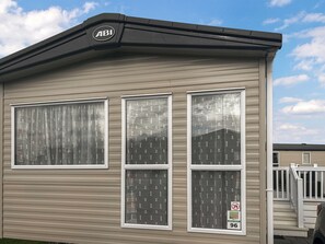 A single-story building with three large windows, a roof with an 'ABI' logo, and a 'No Smoking' sign.