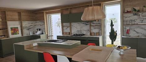 A modern kitchen with a central island, red and white chairs, and a hanging light fixture.