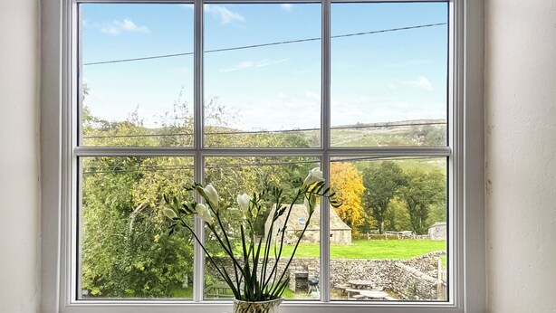 A window with a white frame and a white interior wall.