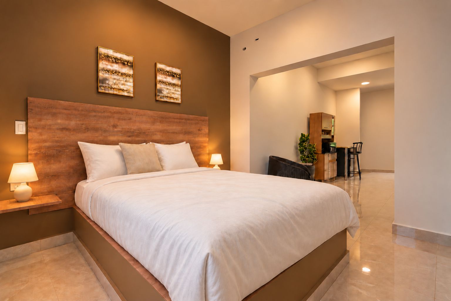 A modern hotel room with a large bed, two bedside lamps, a wooden headboard, and artwork on the wall.