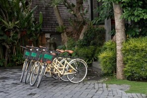 Bicycles parked in a garden with a brick pathway. - Premadhan Sanctuary (Bali)