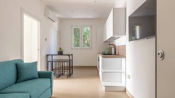 Apartment, 1 Bedroom | Living area | 30-inch TV with satellite channels