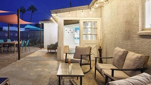 An outdoor patio area with seating and a covered section. - Old Town Scottsdale Retreat: 5BD, 2BA with a Pool, BBQ Grill, & More (Scottsdale)