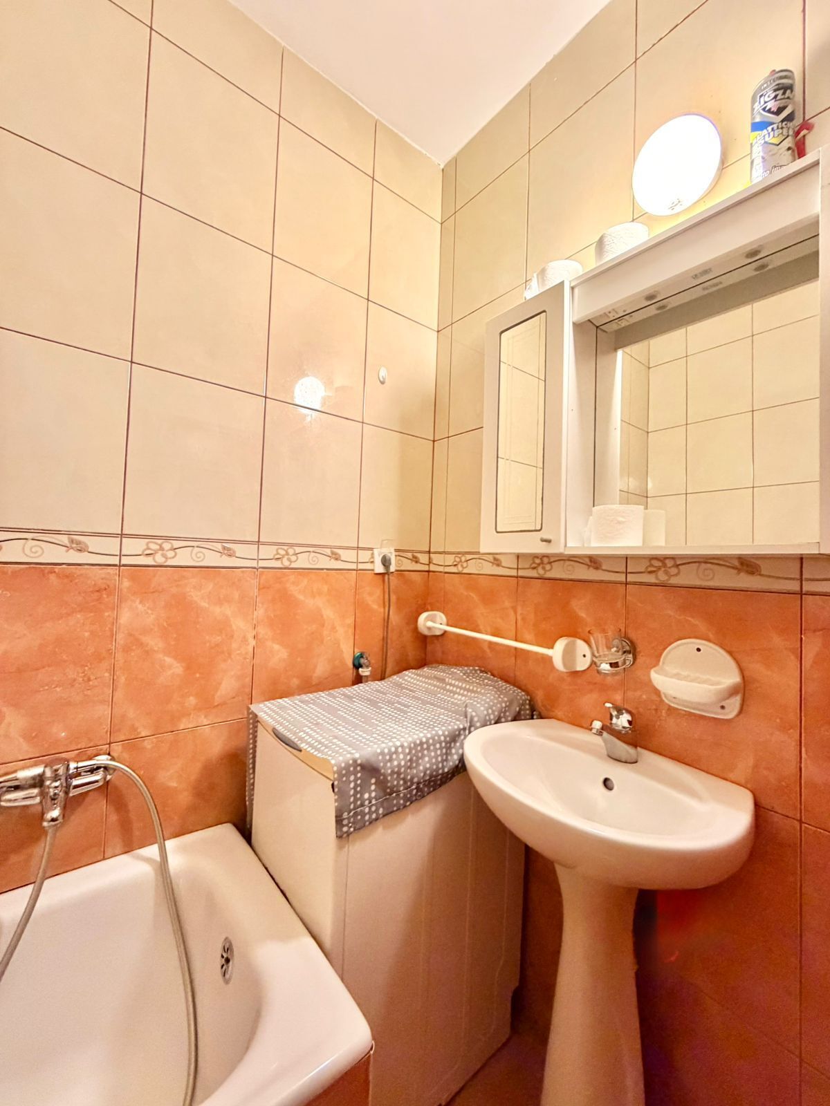 A bathroom with a bathtub, a sink, and a toilet.