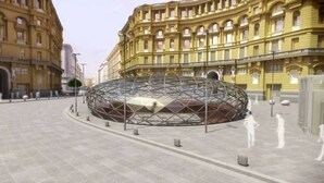 A large, circular, metallic structure in an open plaza surrounded by classical buildings. - DOMUS BAIANO  (Naples)