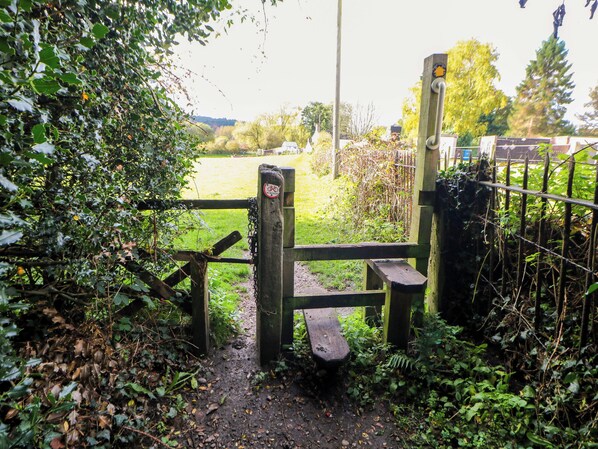 A rustic wooden gate leading to a grassy field. - Shunters Nook (Stafford)