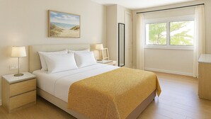 A hotel room with a bed, nightstands, a painting, a window with curtains, and a view of greenery outside. - Beach House in front the sea (Marbella)