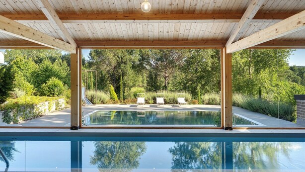 A wooden deck with a pool, surrounded by greenery and a clear view of trees. - Apartment with Terrace and Lake View (Alvignano)