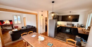 A modern apartment with a living room, dining area, and kitchen.