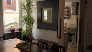 A modern kitchen with a built-in stove, a refrigerator, and a window with a view of the outside. - "Elegant 2 Level Duplex 2 Baths & Bikes -Trastevere" (Roma)