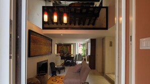 A modern living room with a fireplace, a sofa, and a dining area. - "Elegant 2 Level Duplex 2 Baths & Bikes -Trastevere" (Roma)