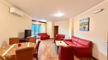 Family Apartment, Balcony, Partial Sea View | Living area | 42-inch flat-screen TV with satellite channels, TV
