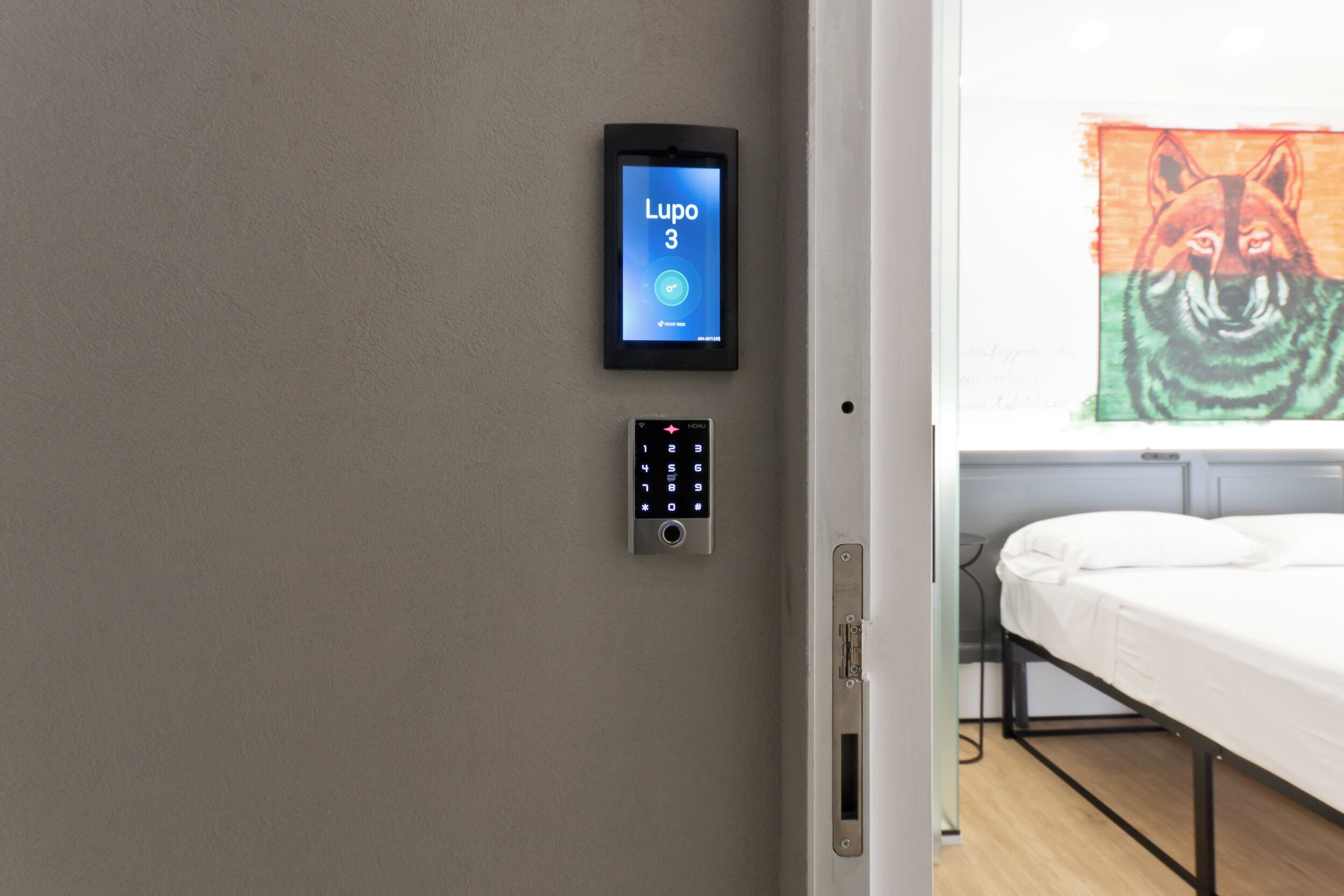 A room with a wall-mounted digital lock and a projection screen displaying a lion's face.