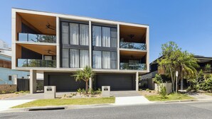A modern two-story building with large windows and a flat roof. - Villa Verda 2 - Luxury Coastal Escape with Private Pool - Holiday Yamba (Yamba)