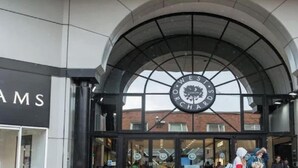 The entrance to West Orchards Centre with a large circular sign above the doors. - Contemporary Comfort Steps from Ricoh Arena (Coventry)