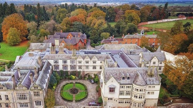An aerial view of Coombe Abbey Park with a large historic building, manicured gardens, and a central circular lawn. - Modern 4-Bed Close to Jaguar Whitley & City C… (Coventry)