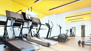 Een sportschool met loopbanden, elliptische trainers en gewichten.