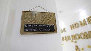 A sign indicating a Wi-Fi password and a check-out time.