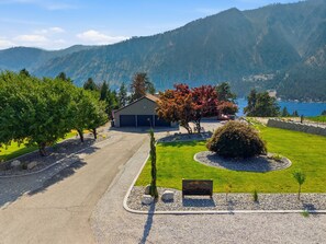 A property with a garage, a well-maintained lawn, and a sign indicating 'Summit Ridge 1935.'