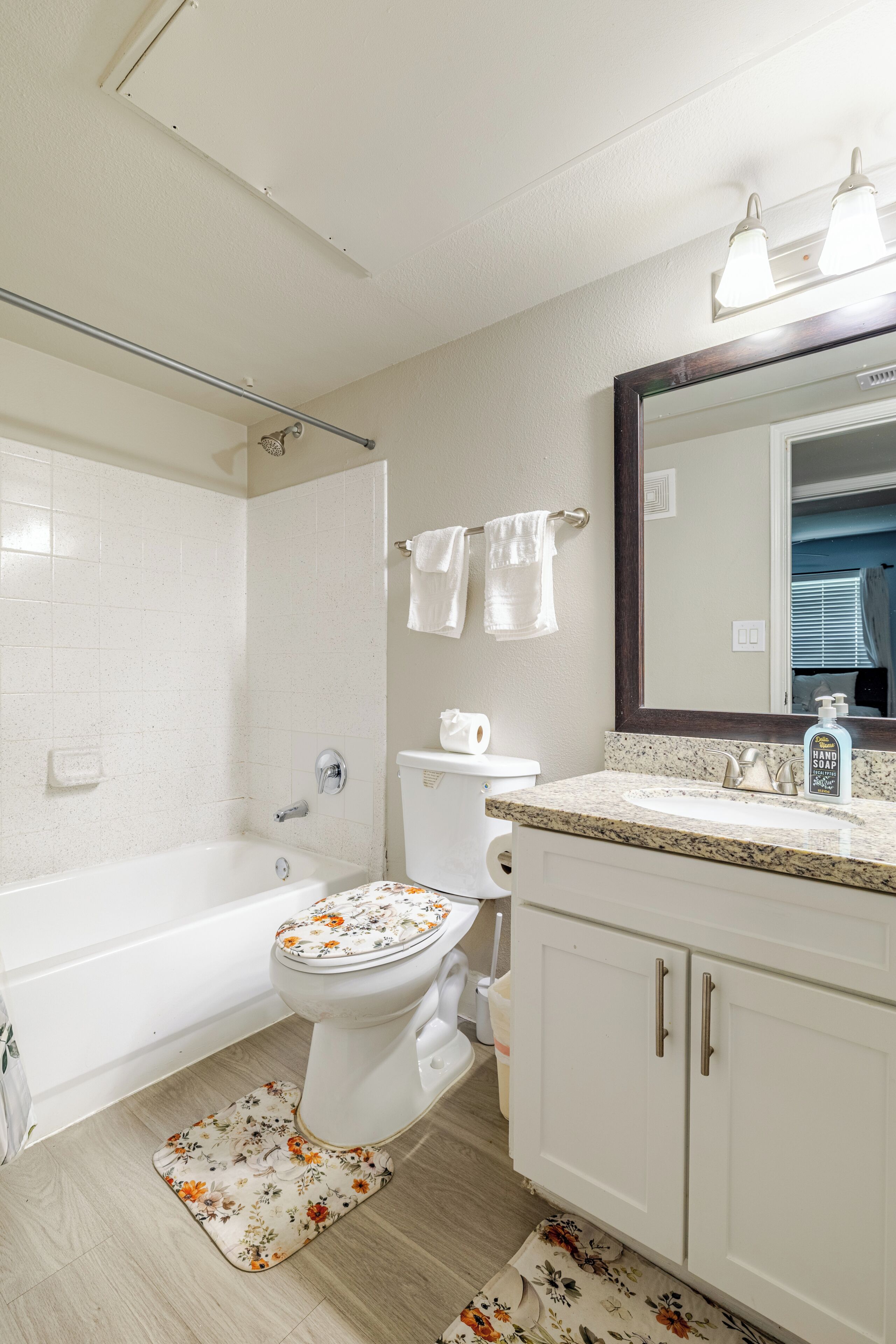 A bathroom with a bathtub, toilet, and sink.