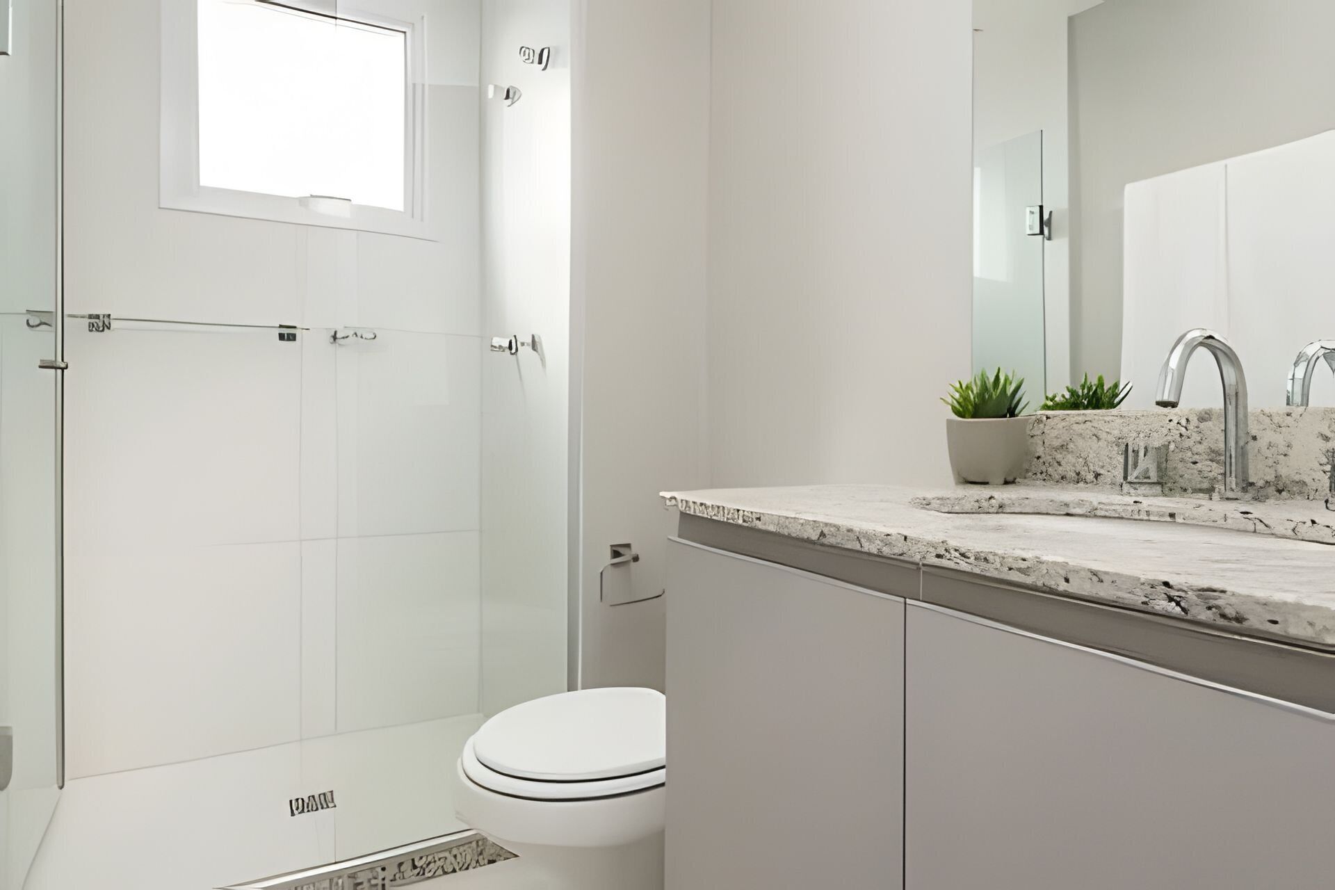 A modern bathroom with a shower, toilet, and sink.