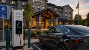 An electric vehicle charging station at a hotel with a stone facade and a covered entrance. - Staybridge Suites Norfolk Airport by IHG (Norfolk)